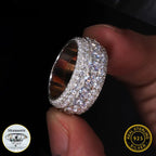 Silver ring with diamonds held by a hand
