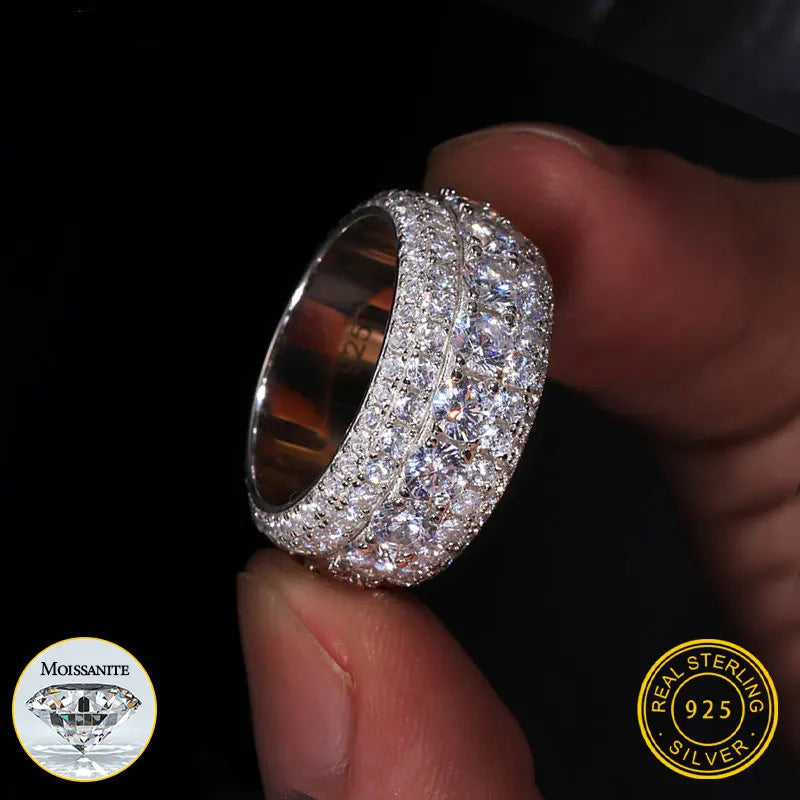 Silver ring with diamonds held by a hand