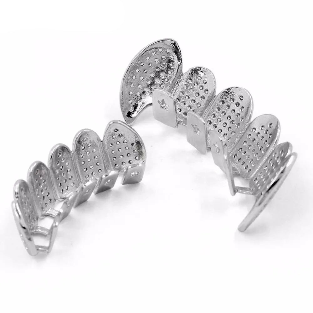 Silver grillz with embedded stones on a white background,